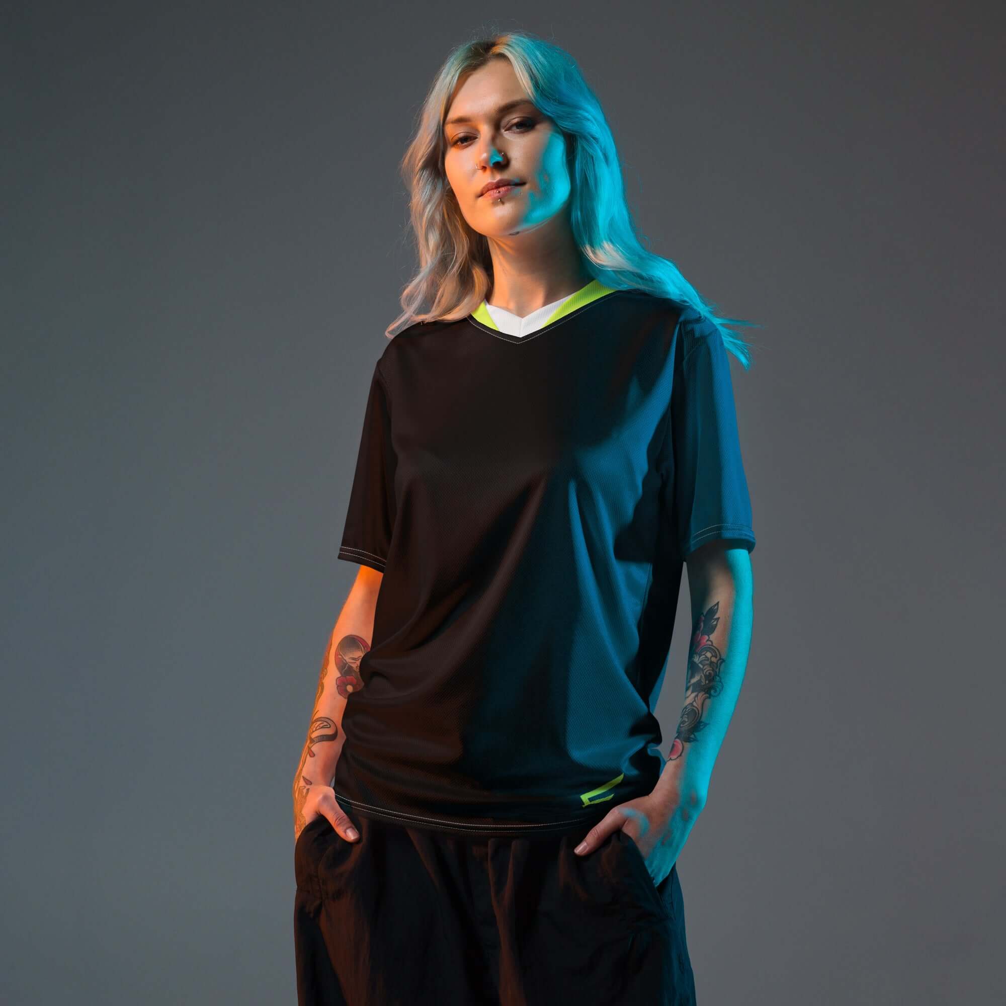 Model wearing Velocity V-Neck Jersey in black with neon surge accents, showcasing performance and style.