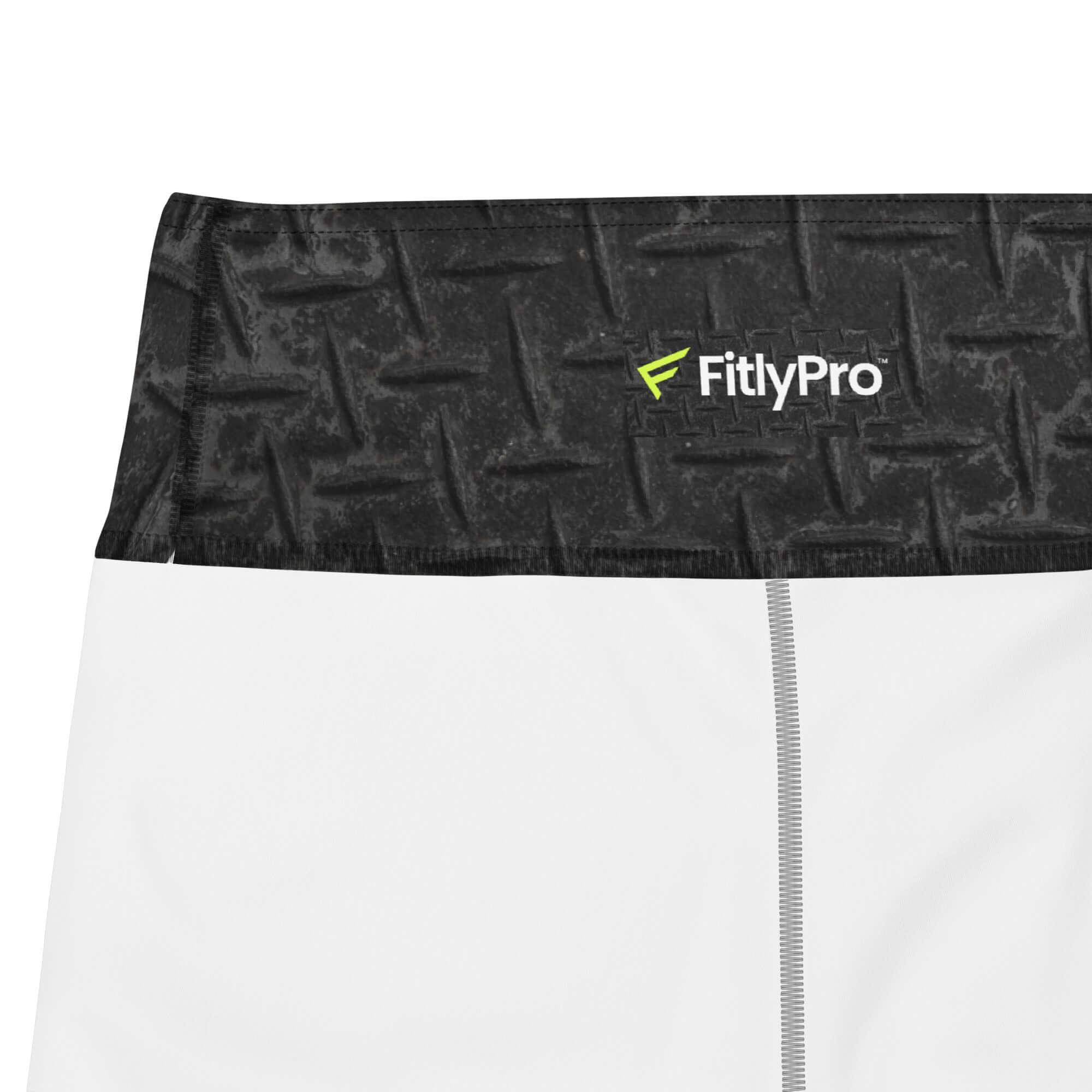 Close-up of high-waisted training shorts waistband featuring FitlyPro logo and textured design.