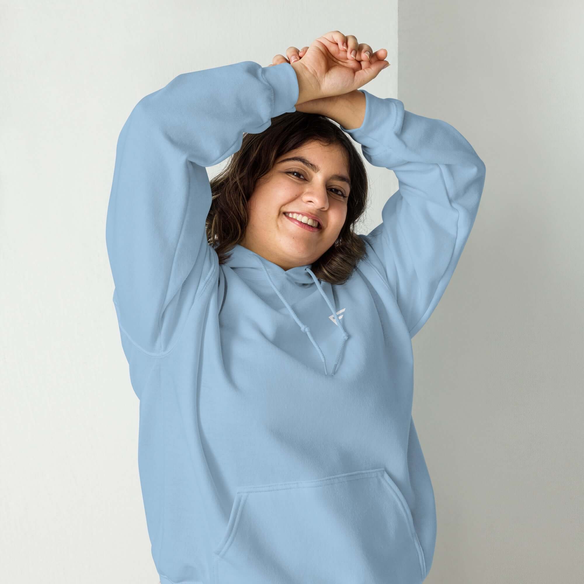 Woman wearing a light blue hoodie, showcasing pastel comfort and style for everyday casual wear.