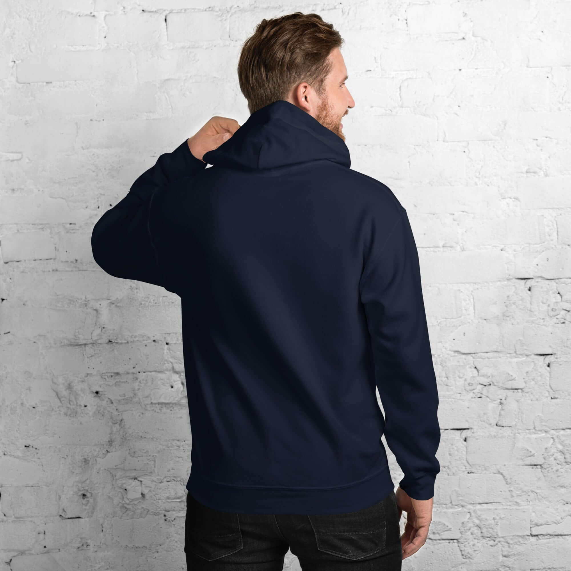 Men's Core Collection hoodie in navy, showcasing a stylish back view against a textured white wall.